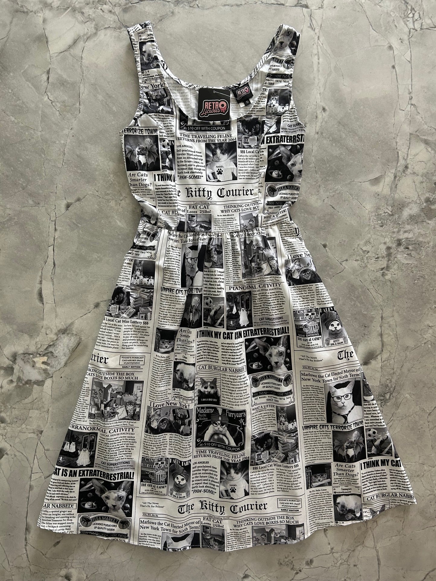 flatlay of newspaper cats fit and flare dress