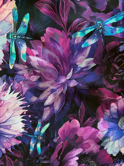 close up of dragonfly floral greta dress showing the dark purple flowers with dragonflies on black background