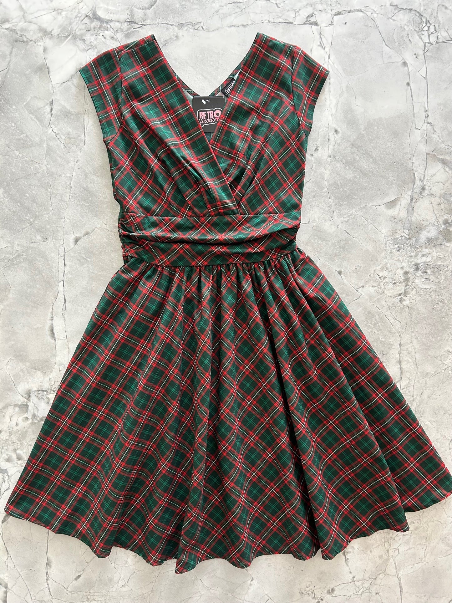 flatlay of holiday plaid greta dress