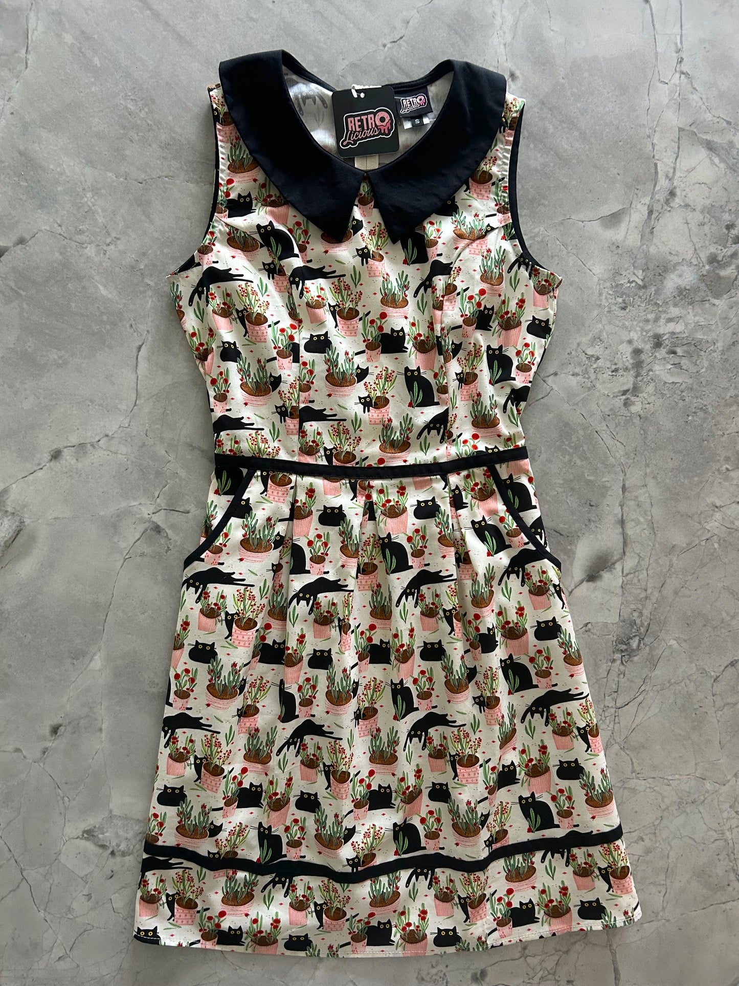 flatlay of cats and plants collared dress