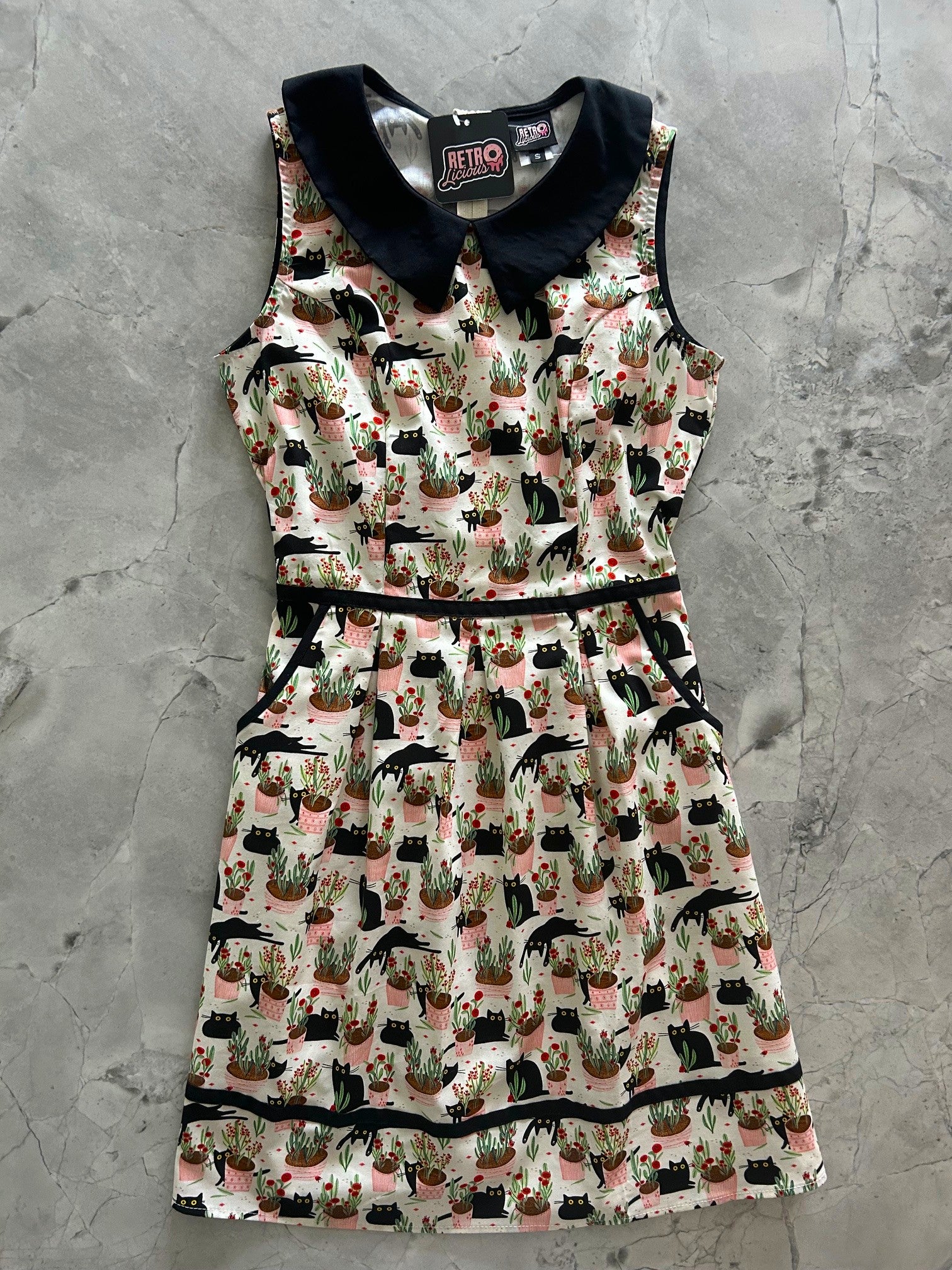 flatlay of cats and plants collared dress