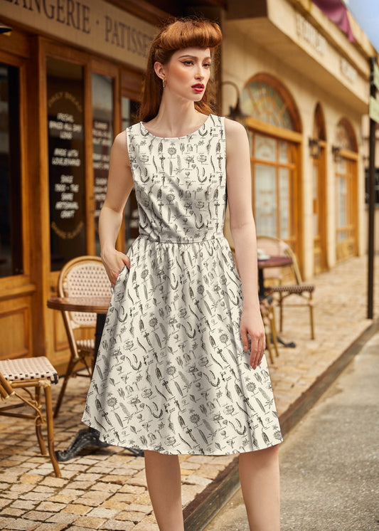 Woman in a patterned dress standing on a street with a café in the background