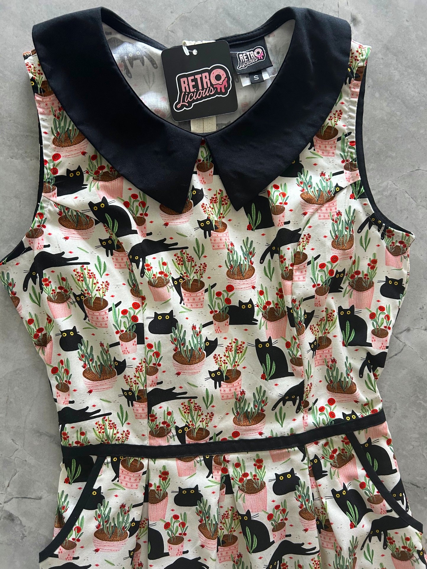 flatlay of bodice ofcats and plants collared dress