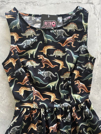 Dinosaur-patterned dress on a light gray surface