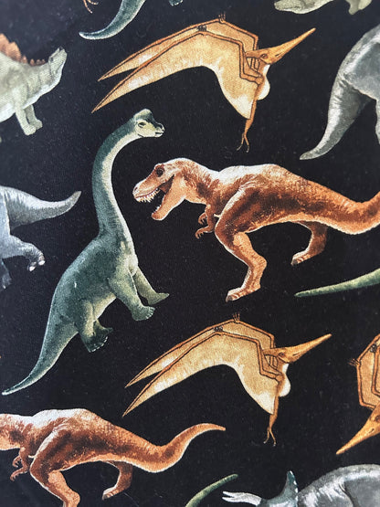 Pattern of stylized dinosaurs on a dark background