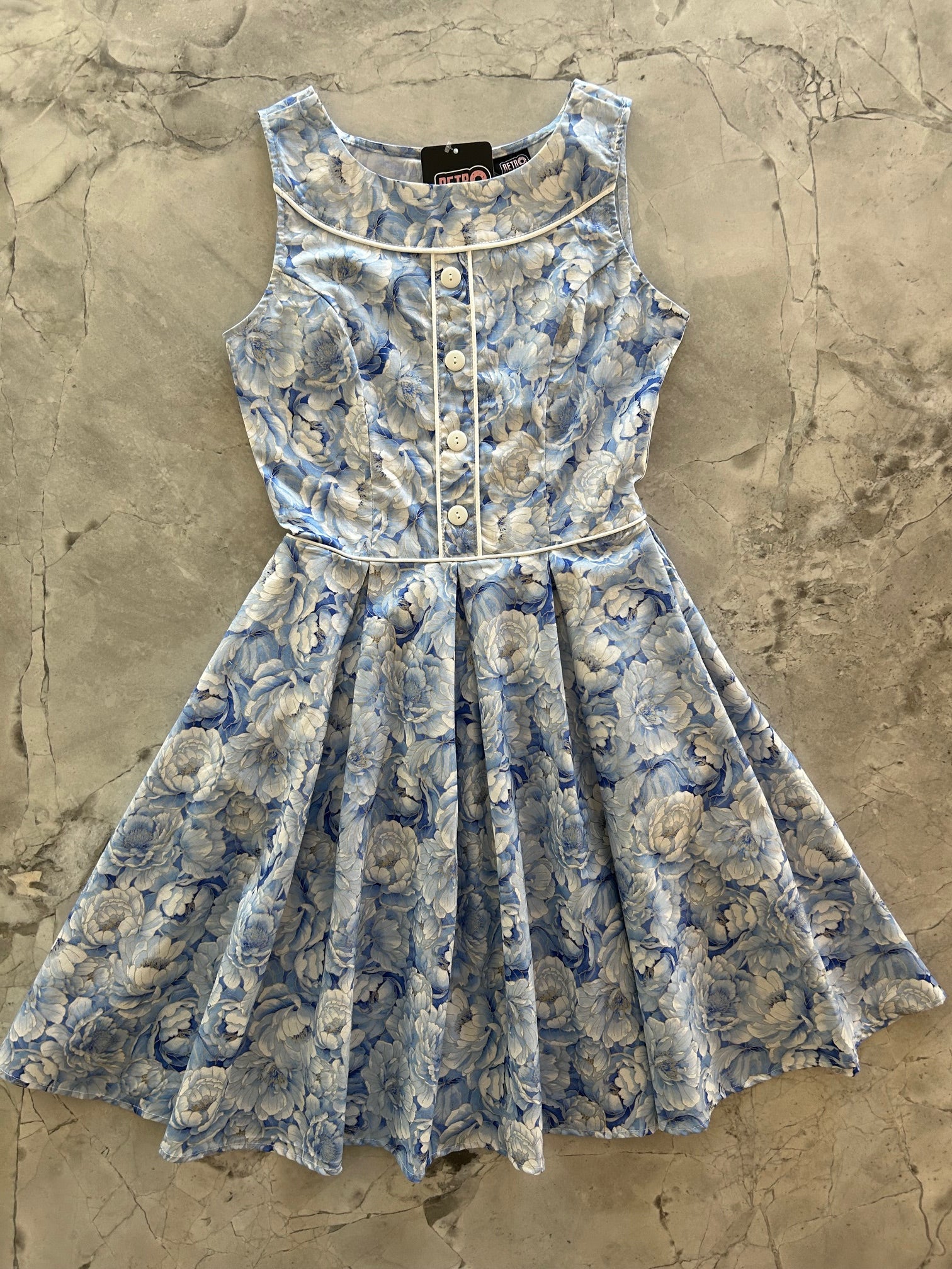 flatlay of elizabeth dress in sky floral