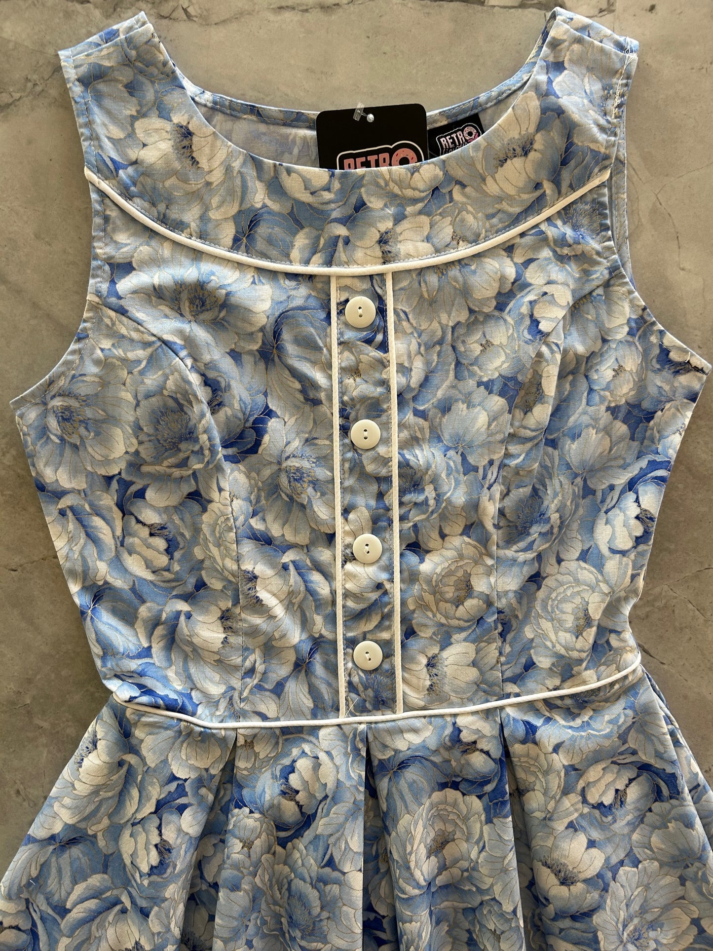 flatlay of close up of bodice of elizabeth dress in sky floral