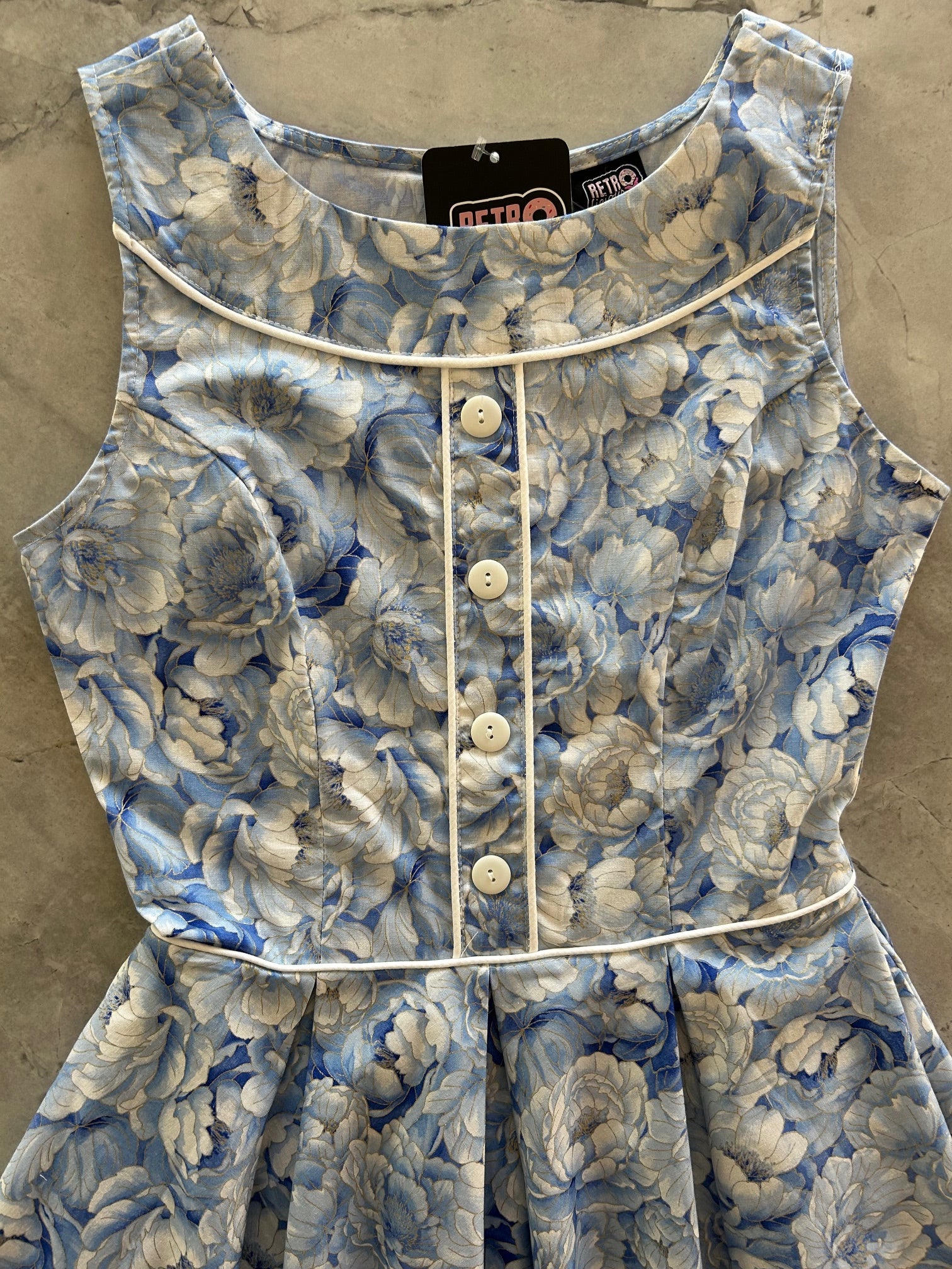 flatlay of close up of bodice of elizabeth dress in sky floral