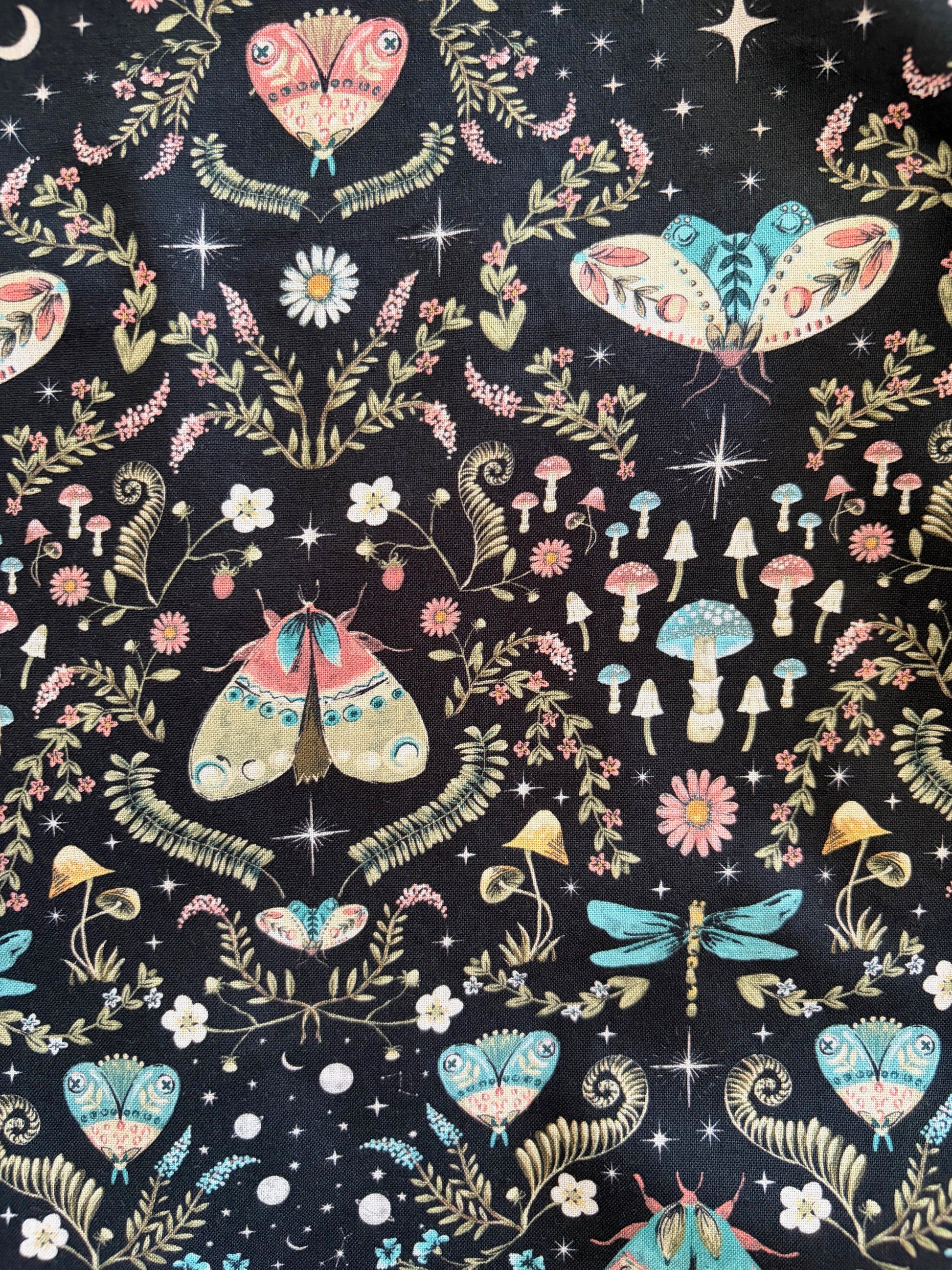 fabric with colorful butterfly and floral pattern on a dark background