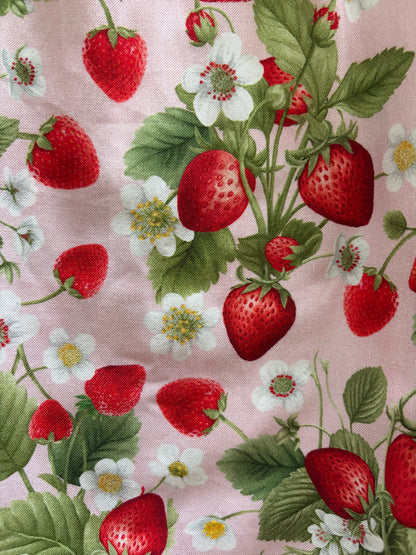 Fabric with strawberry pattern on a pink background