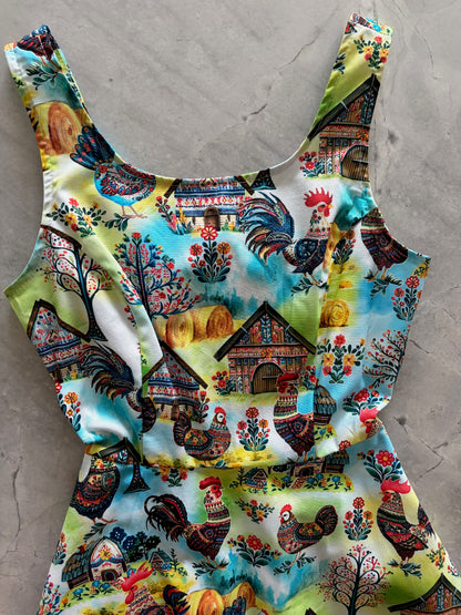 Colorful fabric with rooster pattern on a gray surface