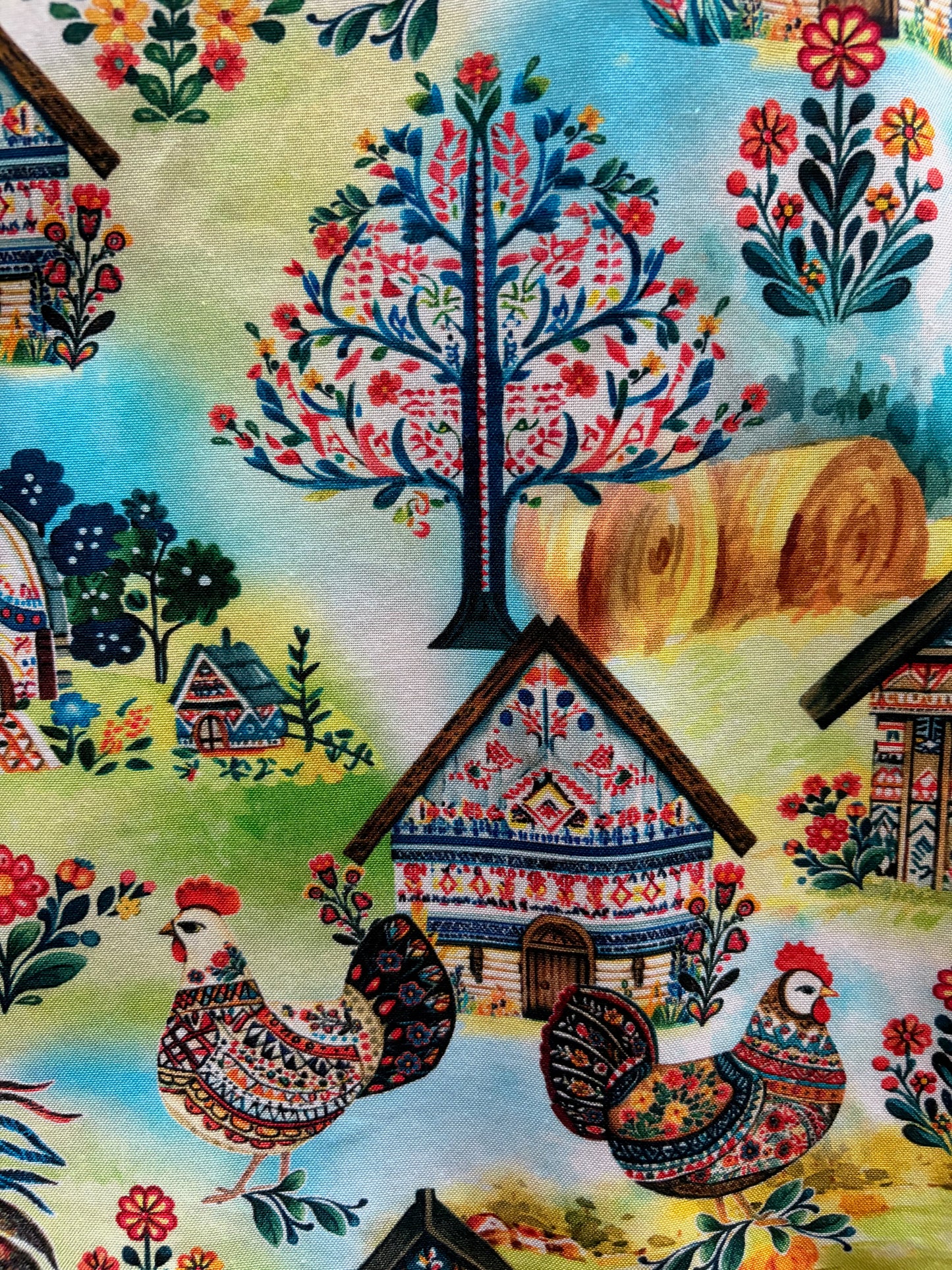Colorful fabric with floral patterns and rooster designs.