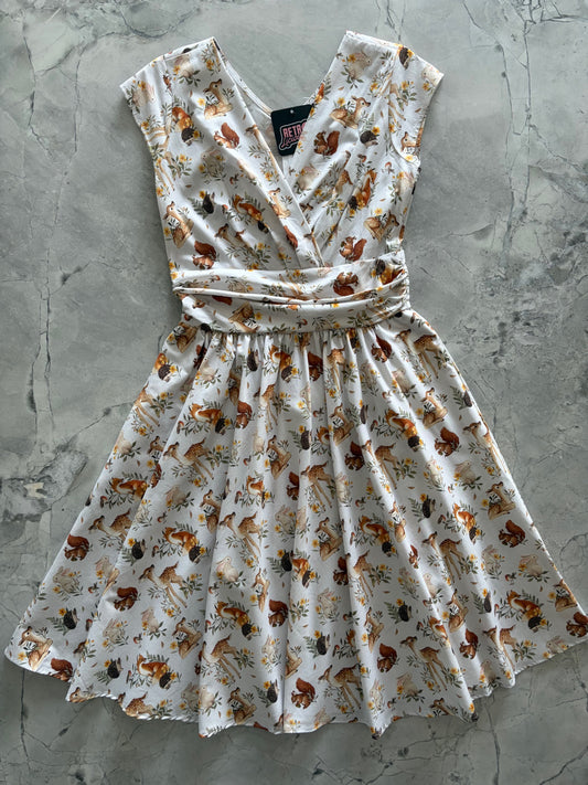 Floral dress with a tie waist on a gray surface