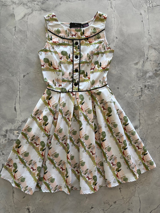 Floral dress with a pattern of small animals on a concrete surface