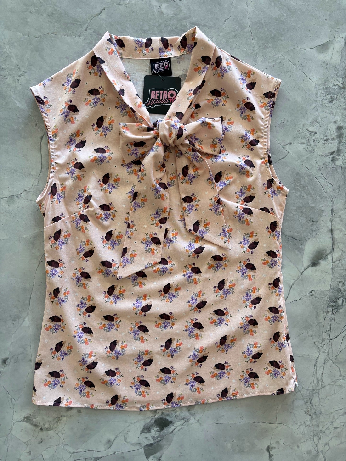 patterned sleeveless top on a textured gray background