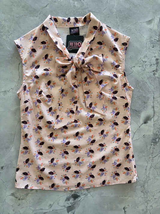 patterned sleeveless top on a textured gray background