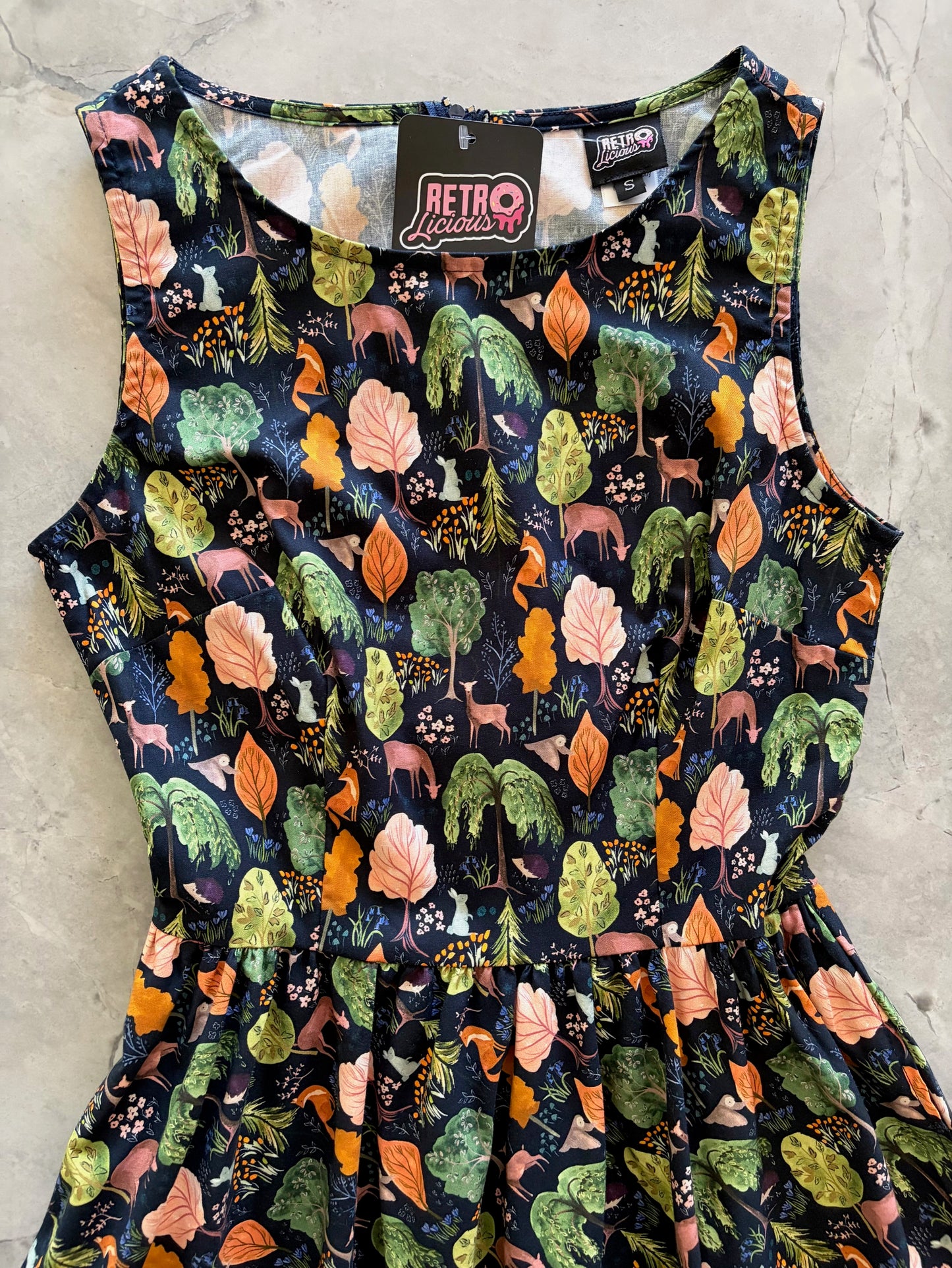Dress with nature-themed pattern on a neutral background