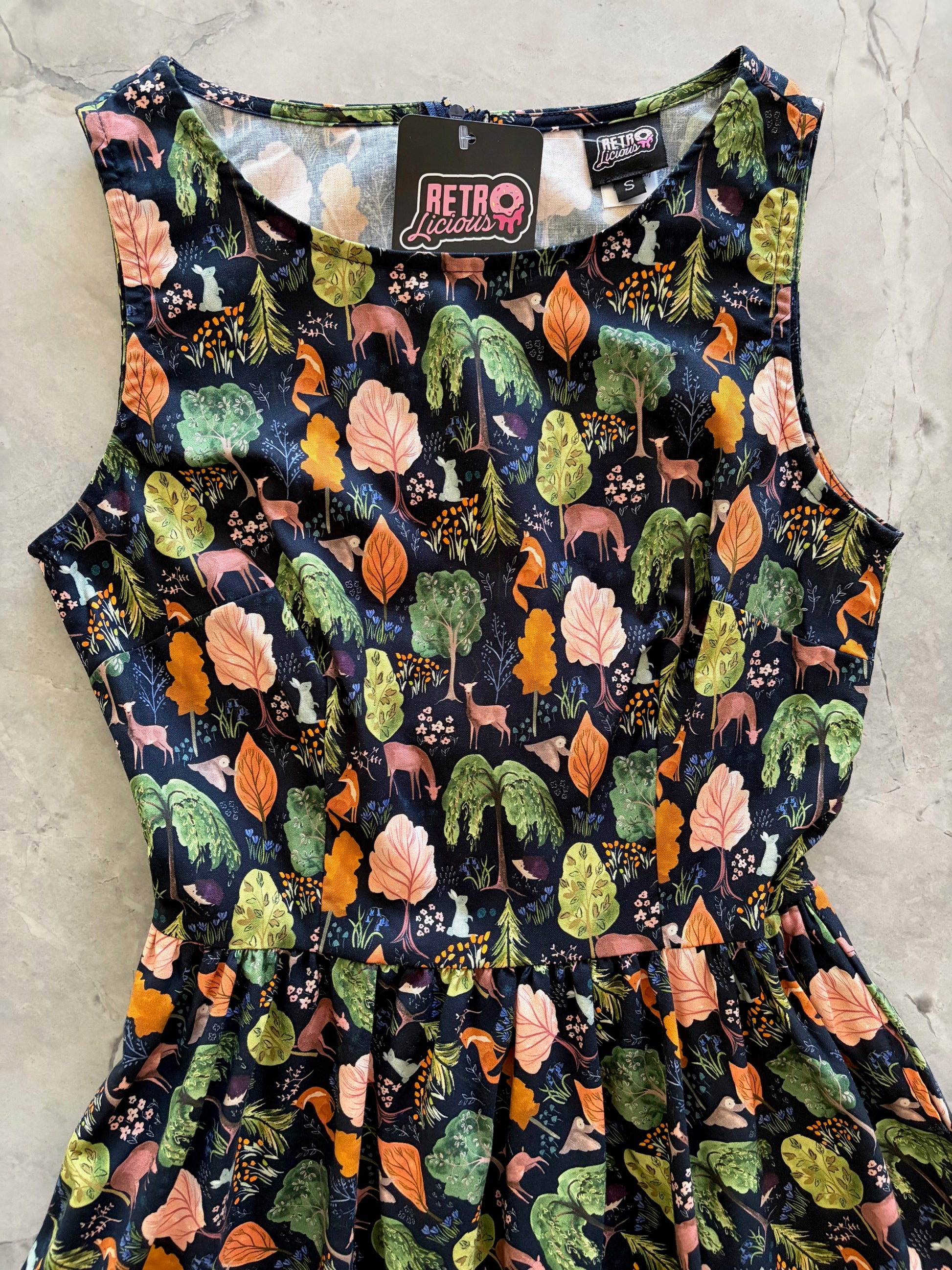 Dress with nature-themed pattern on a neutral background