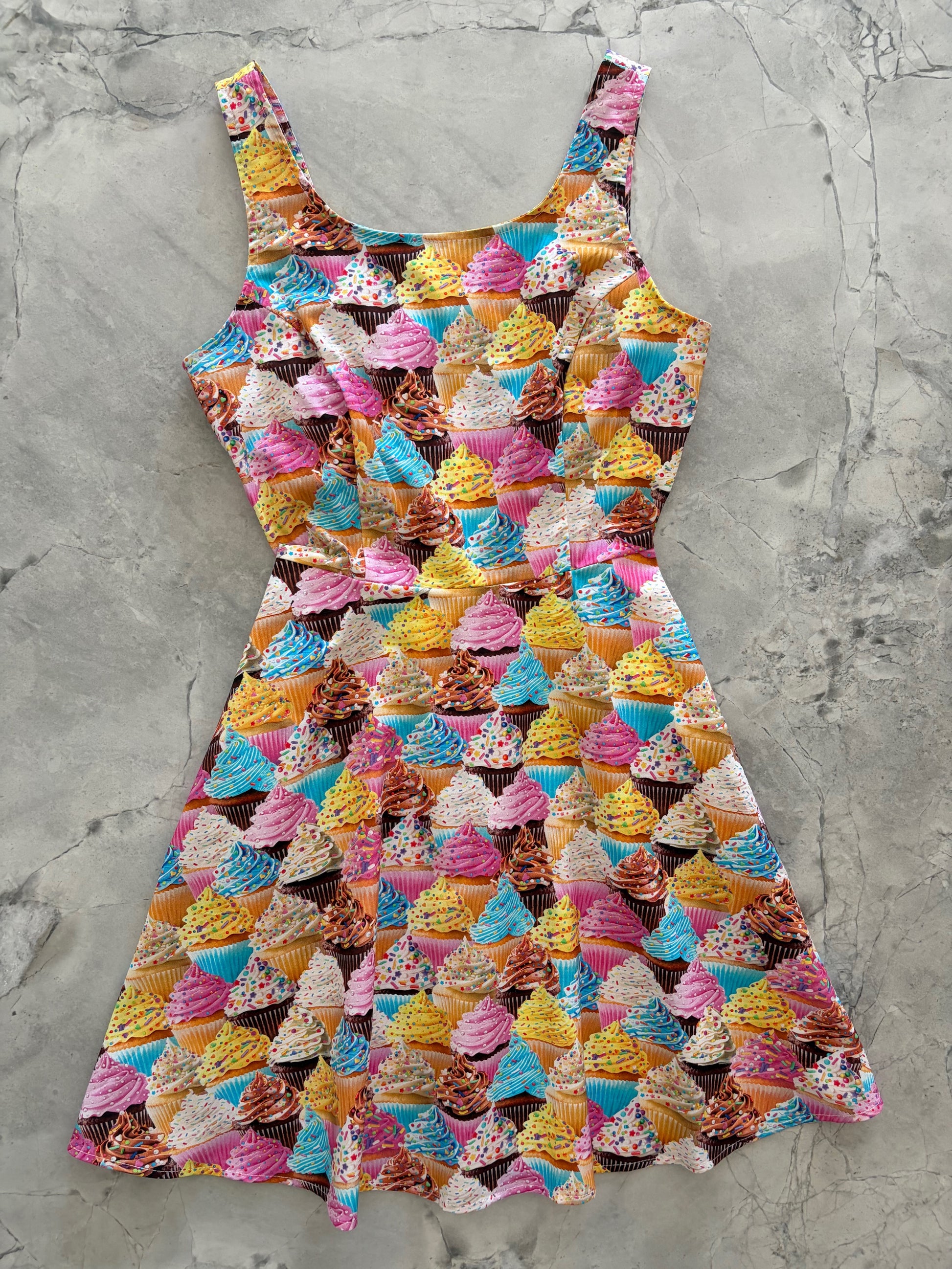 Colorful cupcake pattern on a gray surface