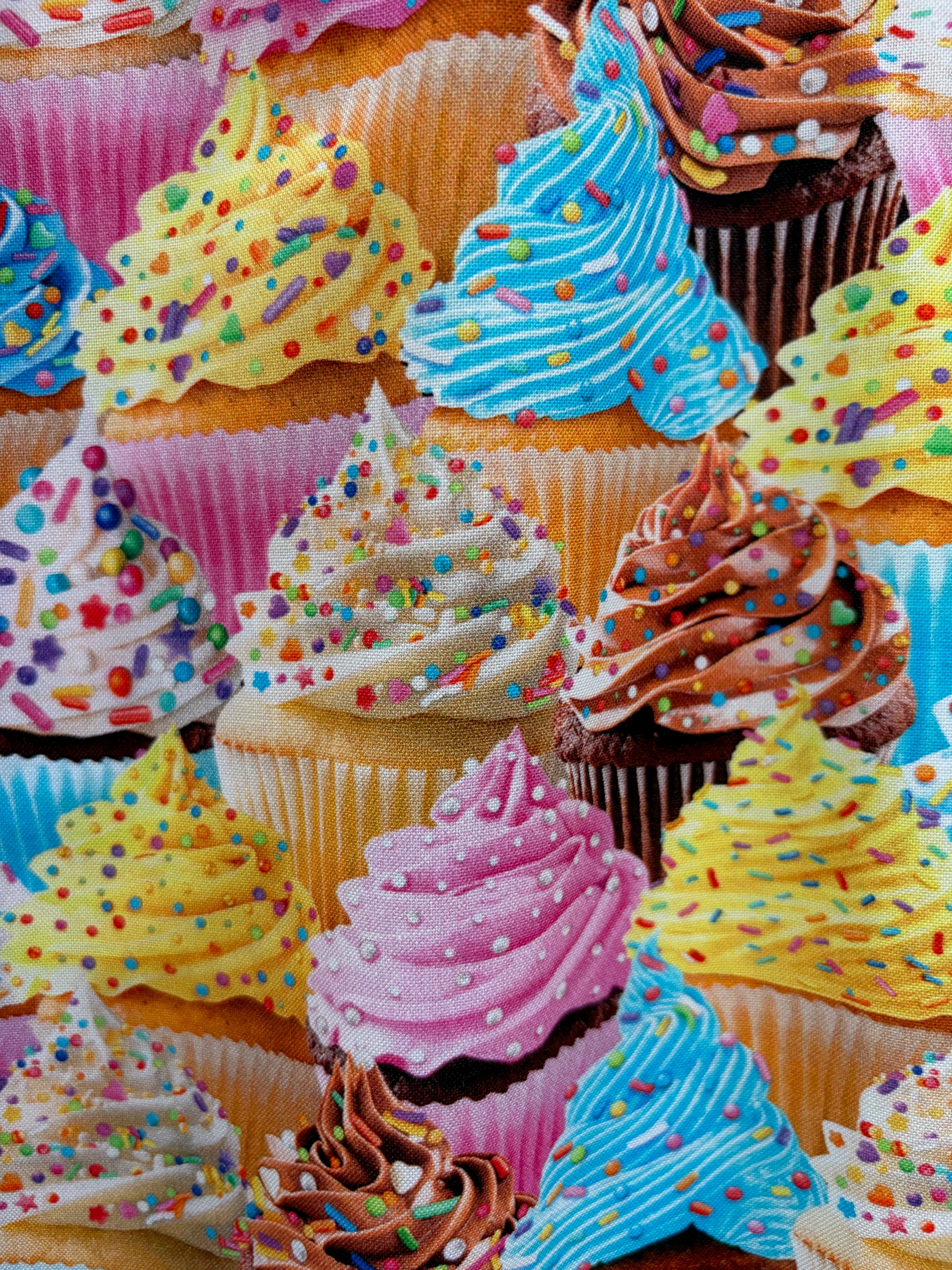 Close-up of colorful cupcakes with various frosting colors and patterns.