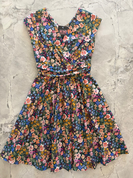 Floral dress on a textured gray surface