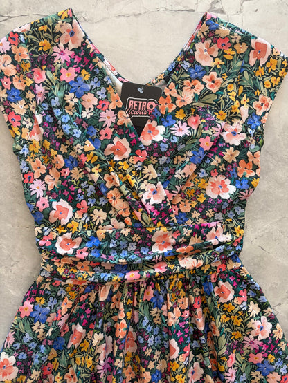Floral dress with a 'Retro' label on a concrete surface