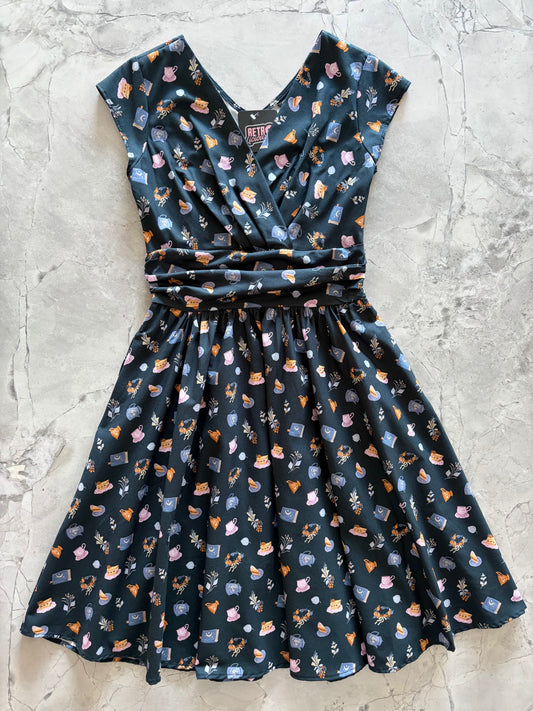 Dark blue dress with animal pattern on a light gray surface