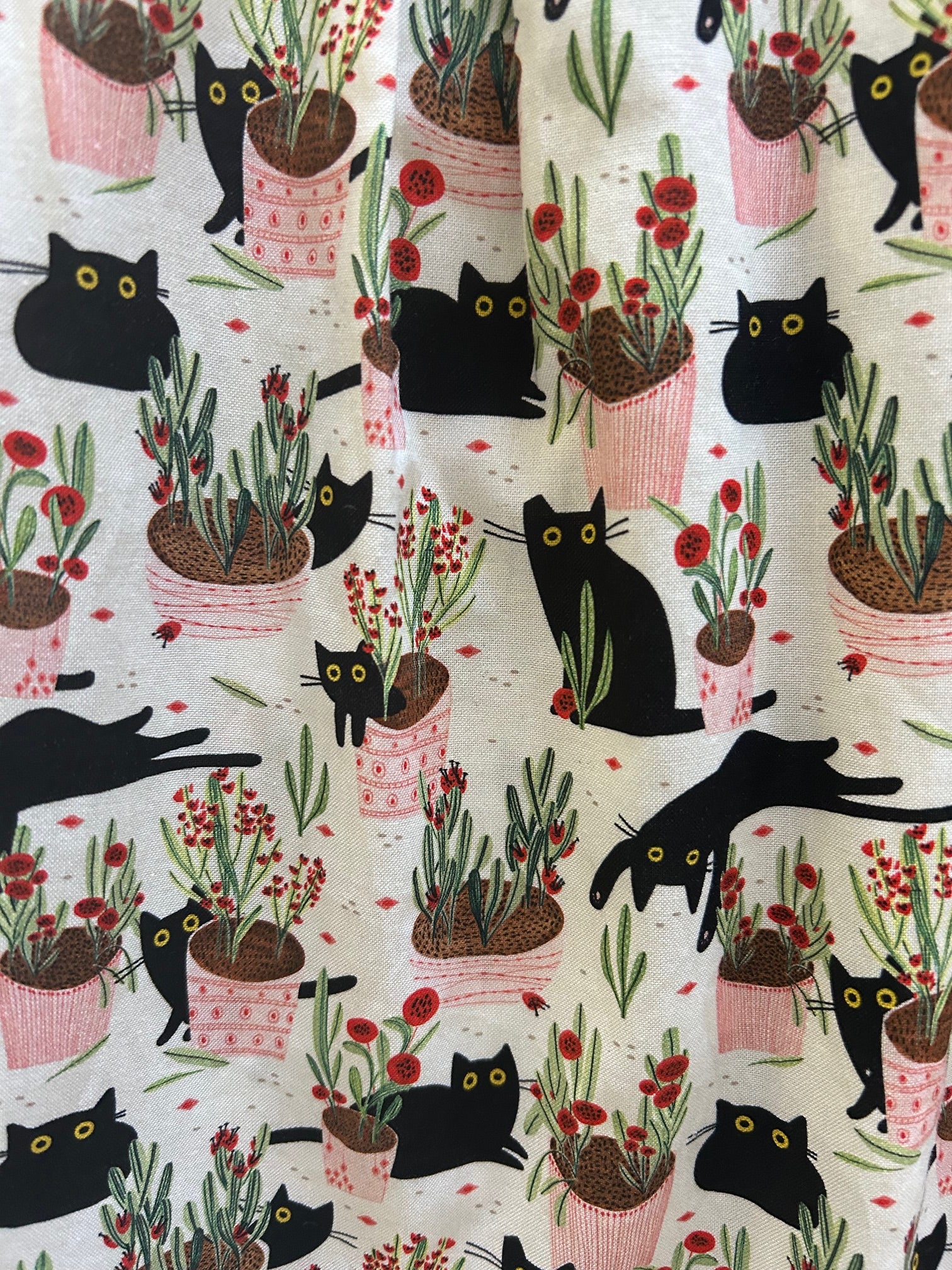 cats and plants print on creme color background