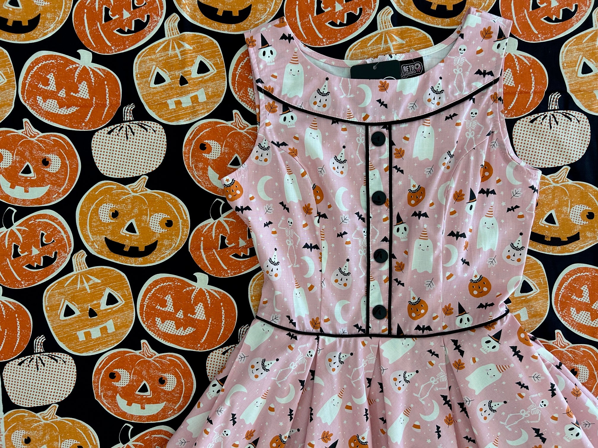 flatlay of elizabeth dress on large pumpkin print