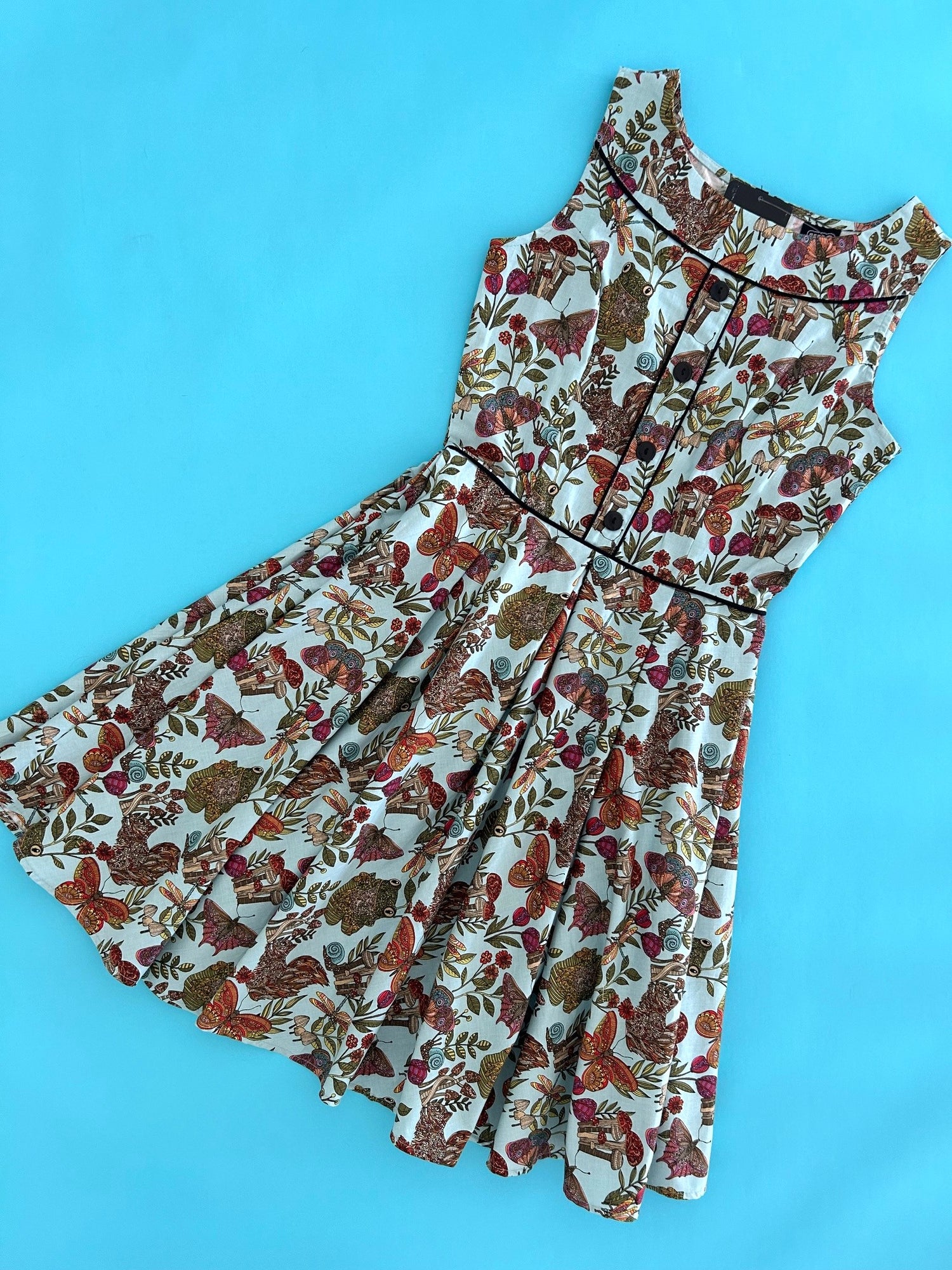 flatlay of our floral elizabeth on a bright blue background