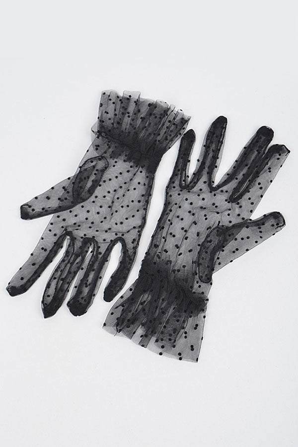 a flat lay image of vintage style polka dot mesh short mesh gloves