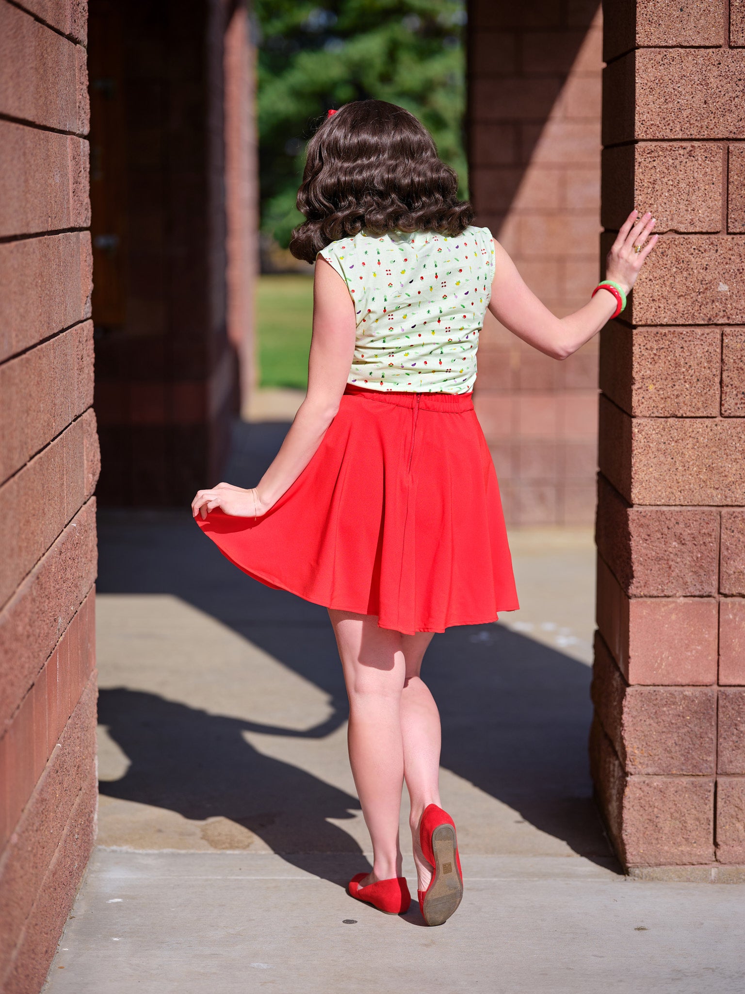 a full length of the back view of a model wearing our veggies bow top