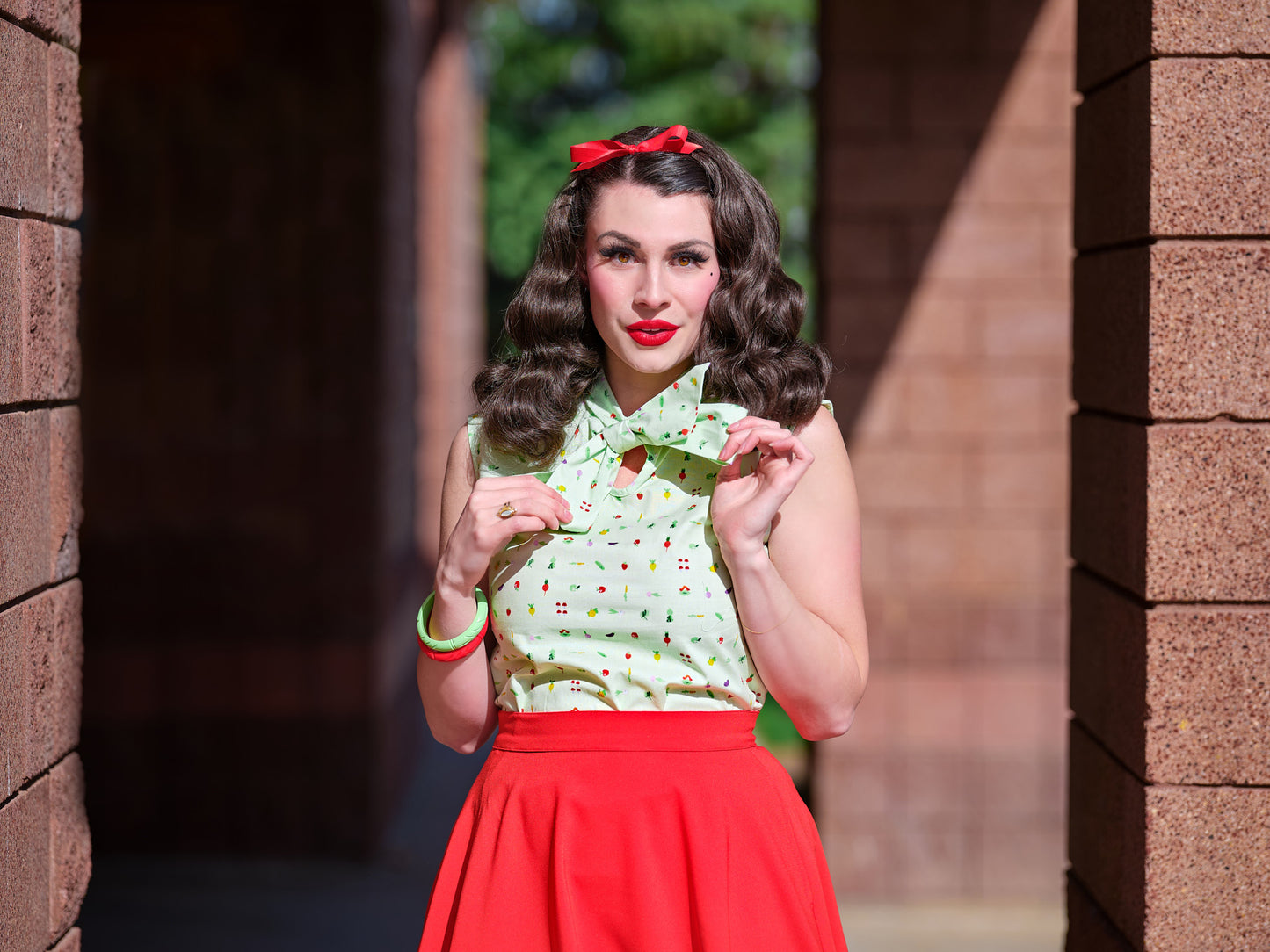 a close up of a model wearing our veggies bow top