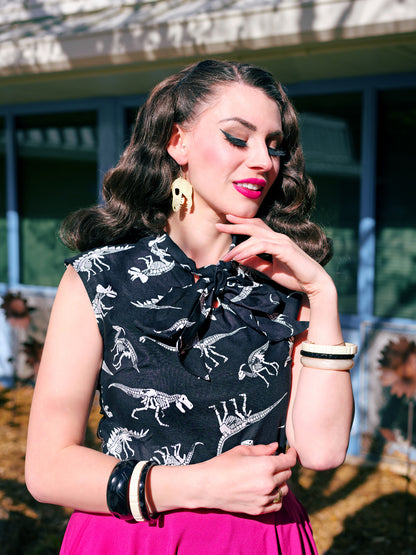 a close up of a model wearing our glow in the dark fossils bow top