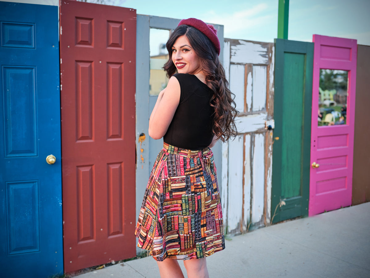 a full size back image of a model wearing our Don't Judge a Book by its Cover Skirt
