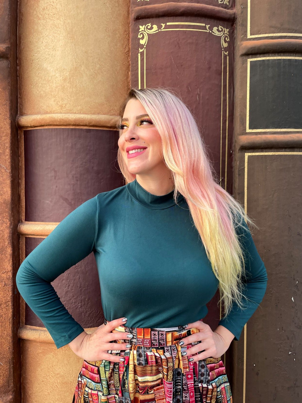 a close up of a model wearing our green mock neck top