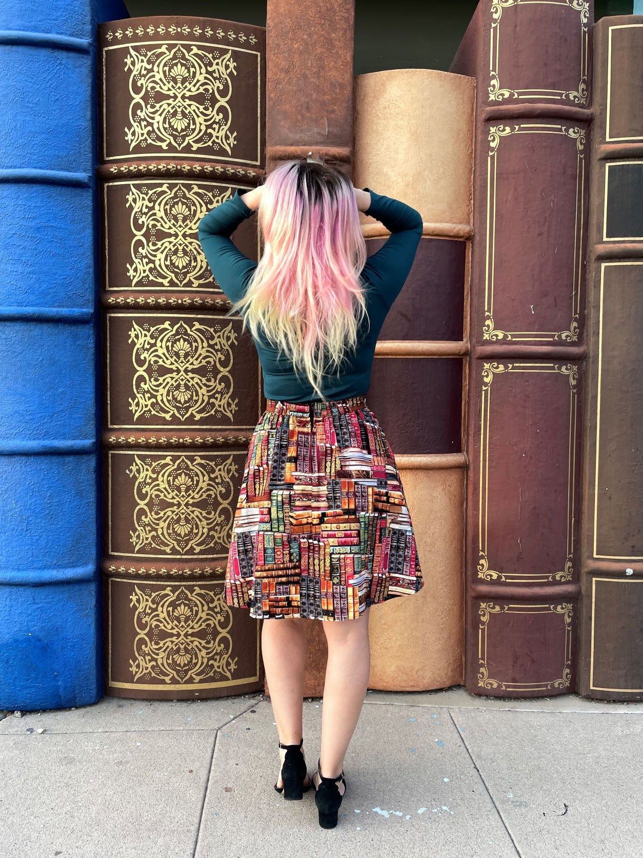 a full length of the back view of a model wearing our green mock neck top