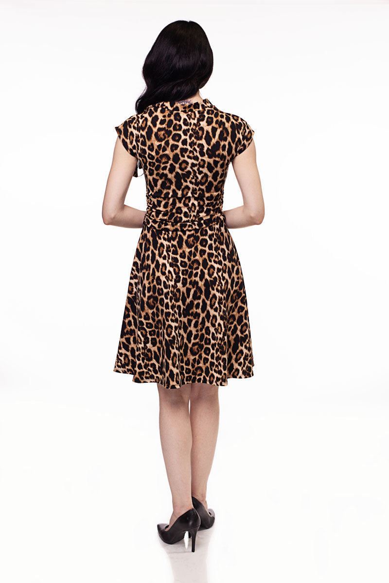 a full size image of a model showing the back side of our Leopard Bombshell dress