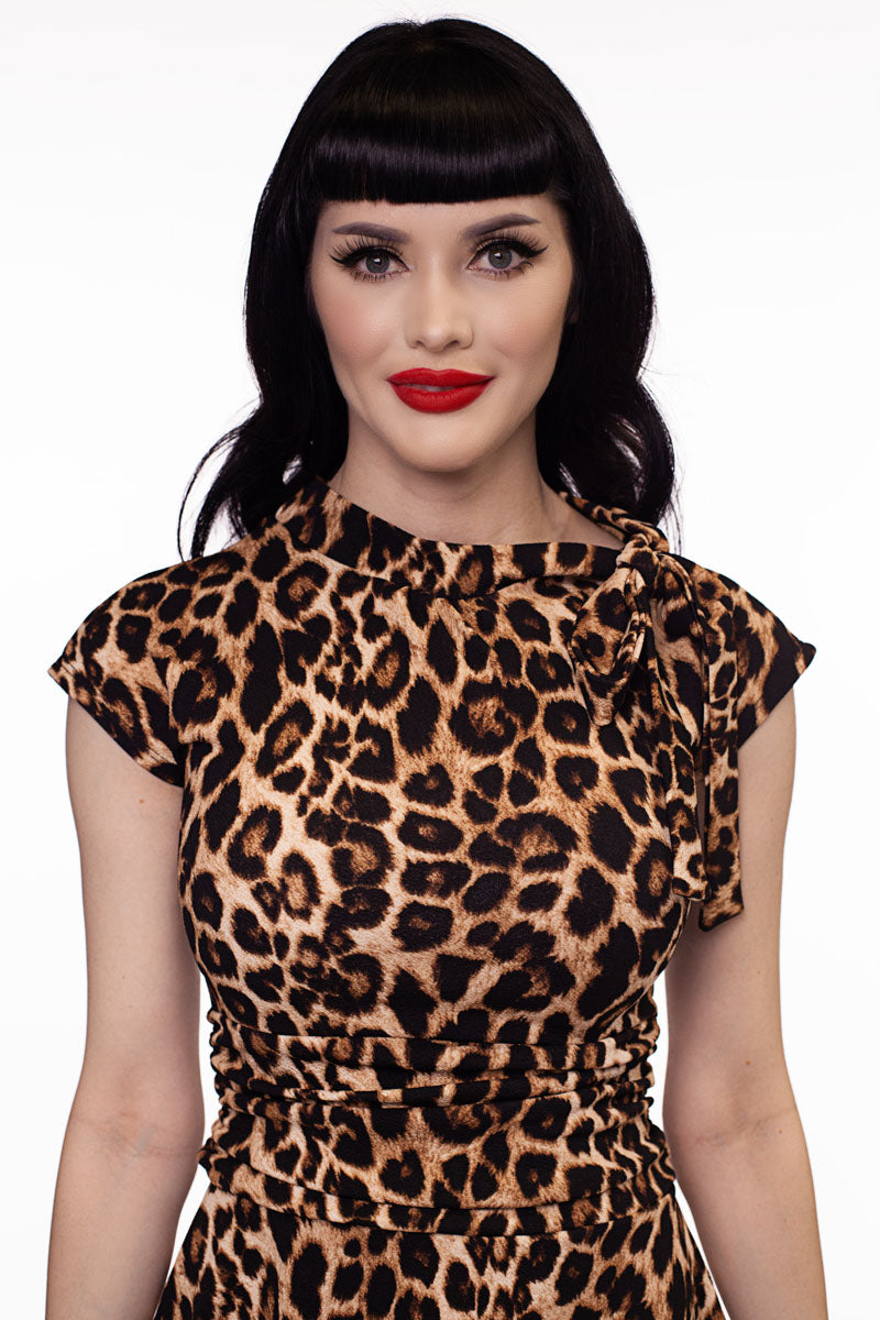 a close up image of a model wearing our Leopard Bombshell dress