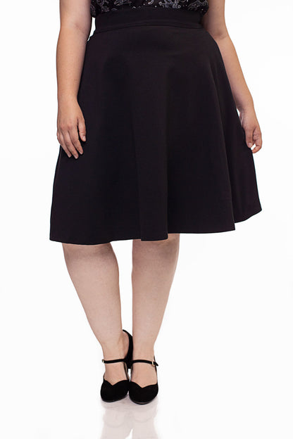 a plus size model wearing a retro style charlotte skirt in black