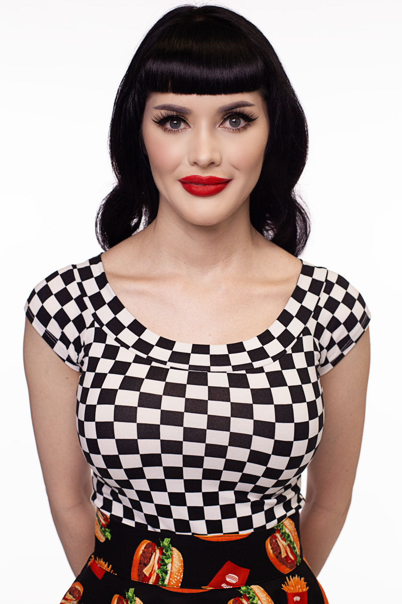 close up of model wearing our boat neck top in checkers