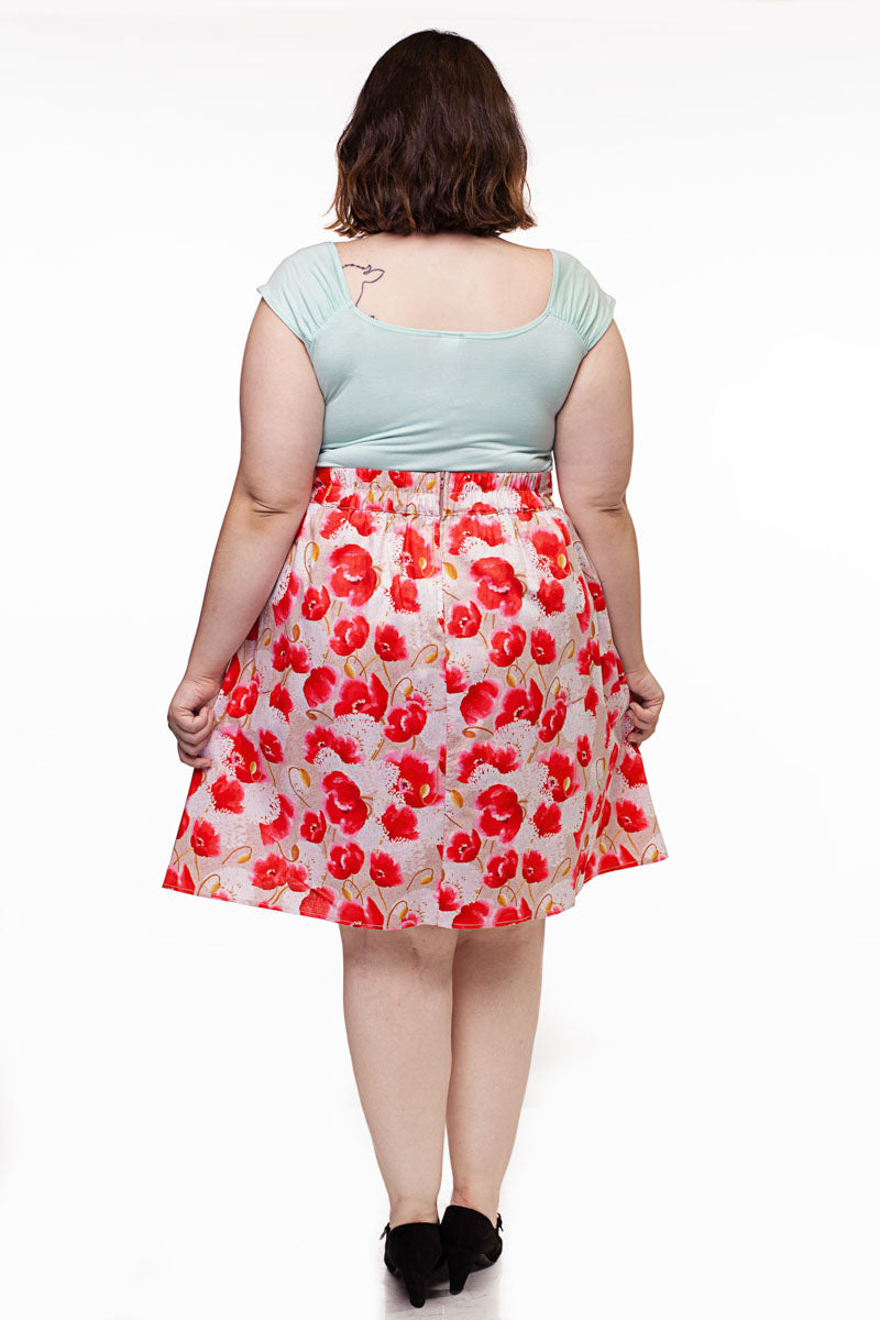 a back side of a plus size model wearing our floral pink a-line skirt