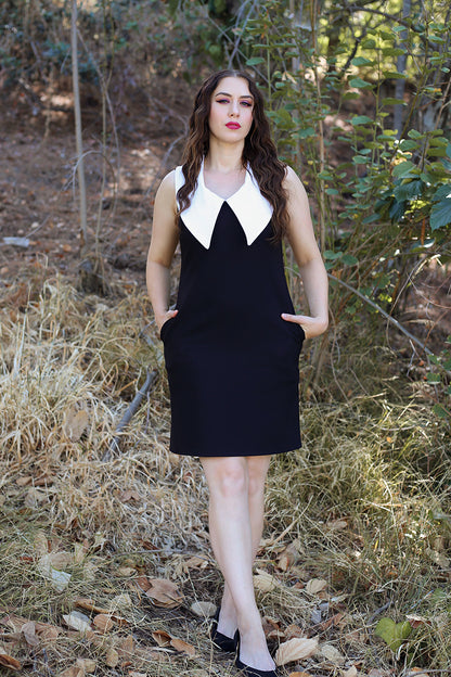 vintage inspired goth dress being worn by model standing in a forest setting