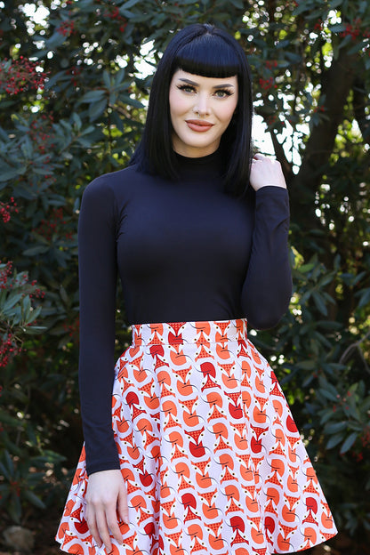 model standing in front of trees wearing our mock neck top in black