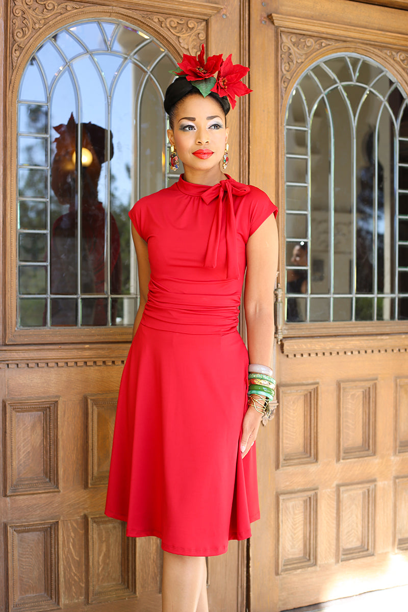 Three quarter length shot of model wearing a red vintage dress