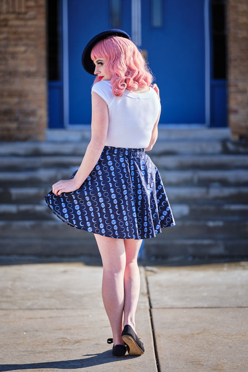 a model standing in front of stairs wearing lets phase it skater skirt