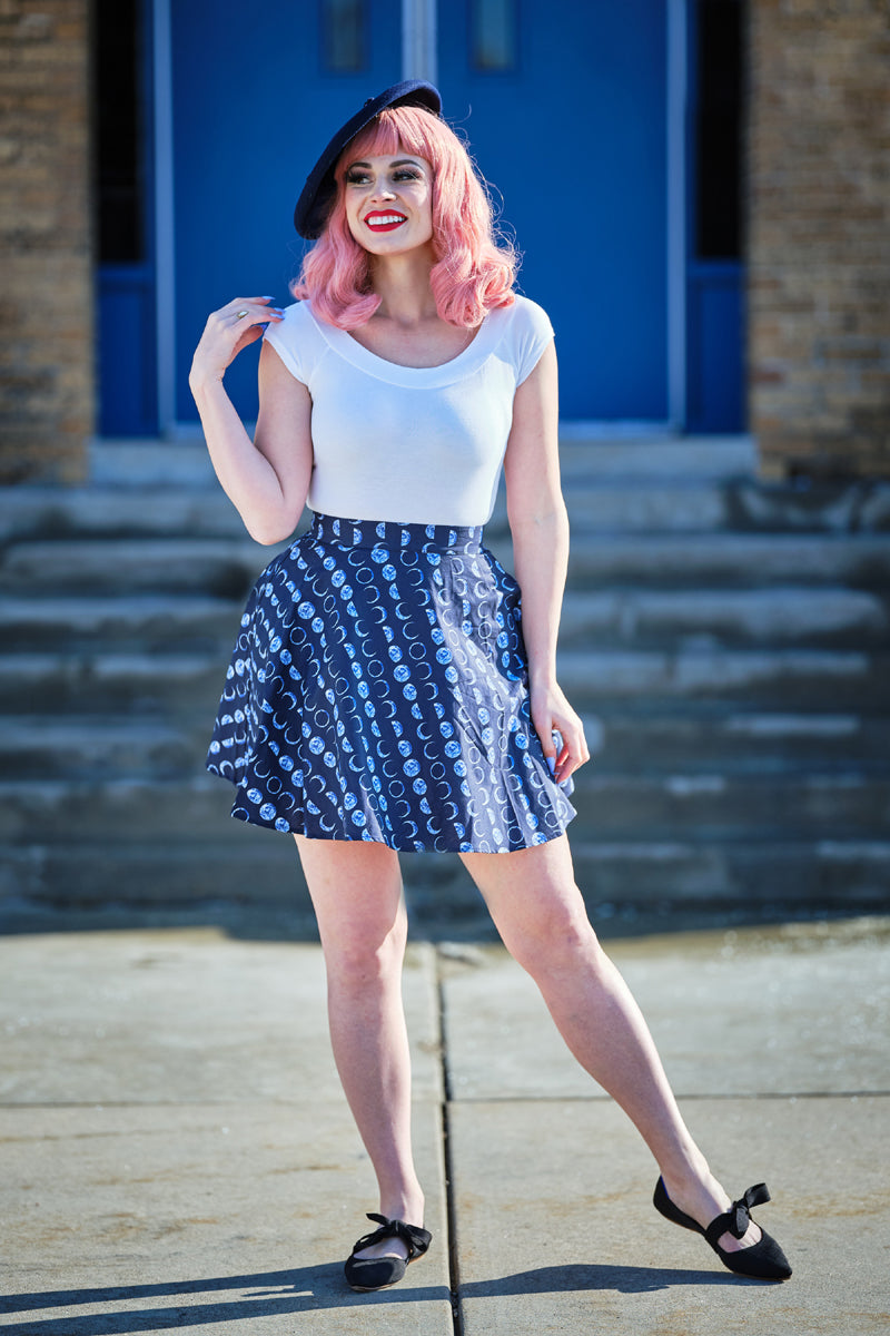 a model standing in front of stairs wearing  lets phase it skater skirt
