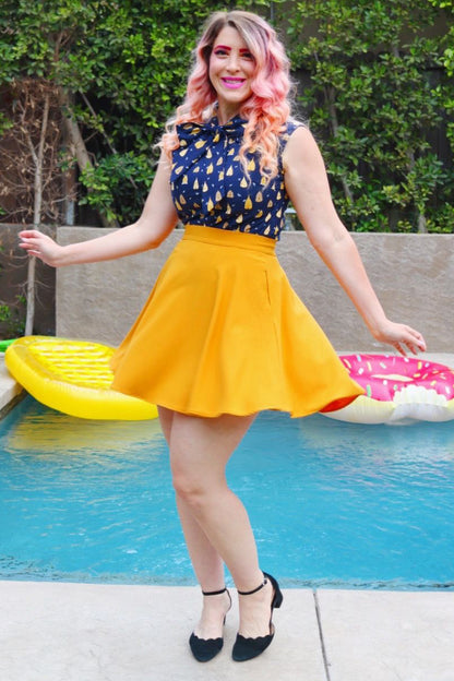 full length of model standing in front of a pool wearing our beehive bow top