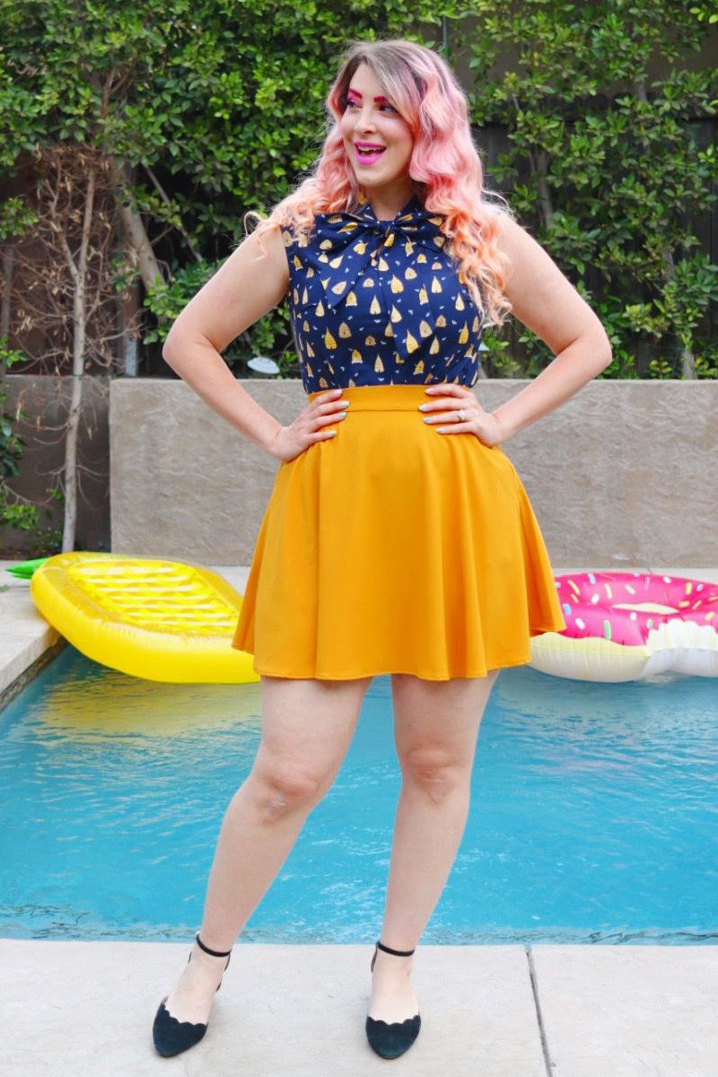 full length of model standing in front of a pool wearing our beehive bow top