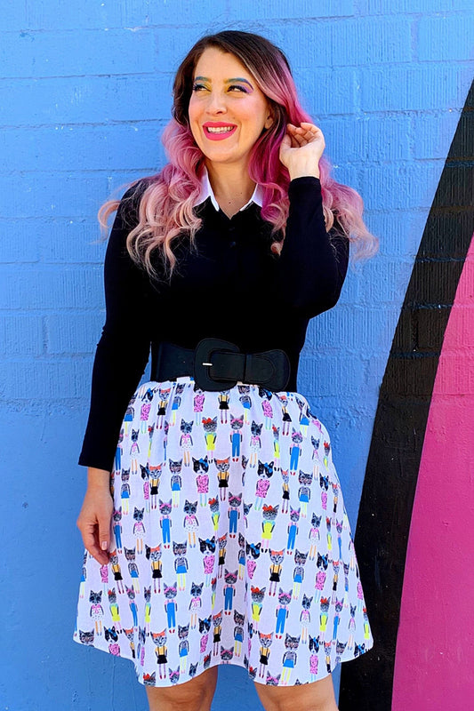 a model standing in front of a colorful painted wall wearing the cats a-line skirt